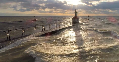Lighthouse lake michigan with sunset pull back areial flyover 4K Video stock 89188321