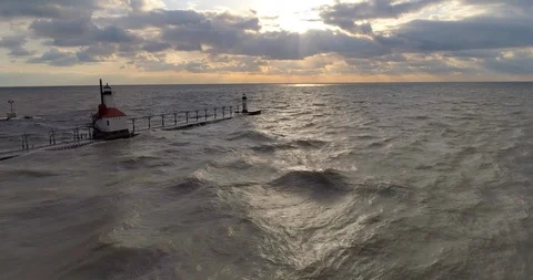 Lighthouse lake michigan with sunset pull back areial rise up Video stock 89189398