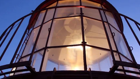 Lighthouse lantern light mechanism rotating in late afternoon. Stock Footage 94457520