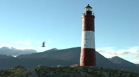 Lighthouse Les Éclaireurs with sky and mountains background Stock Footage 64182098