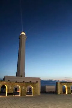 Lighthouse with light beam at sunset Stock Photos