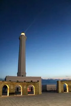Lighthouse with light beam at sunset Photos
