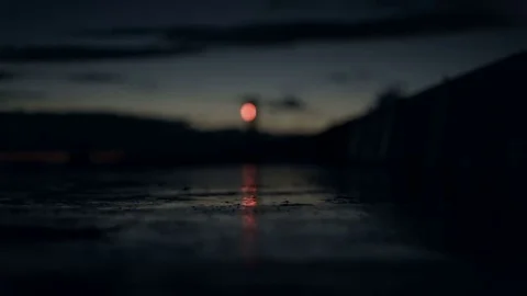 Lighthouse light flashes on the pier reflection in the late evening after sunset Stock Footage 69205423
