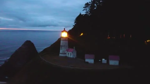 Lighthouse Light Lit Up Spinning Beam Shining Bright Over Pacific at Dusk Stock Footage 300283450