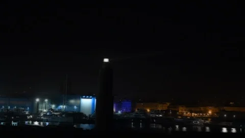 Lighthouse light at port by night Stock Footage 111230123
