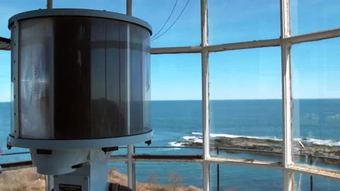 Lighthouse light shines on ocean day Stock Footage 134304167