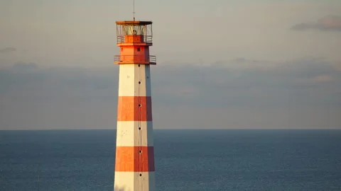 Lighthouse light spining around. Red and white lighthouse. Stock Footage 99386236