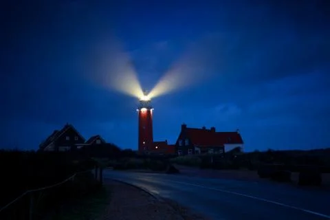 Lighthouse lightbeams in night Stock Photos