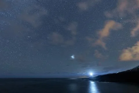 Lighthouse lightning under the dark night with stars Stock Photos
