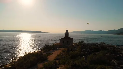Lighthouse of Makarsa during sunset - aerial push in shot Stock Footage 114414215