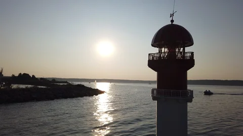 Lighthouse of a marina with a boat in the background 스톡 동영상 115095909