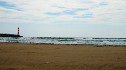 A lighthouse marks the entrance to a seacoast Stock Footage 101347134