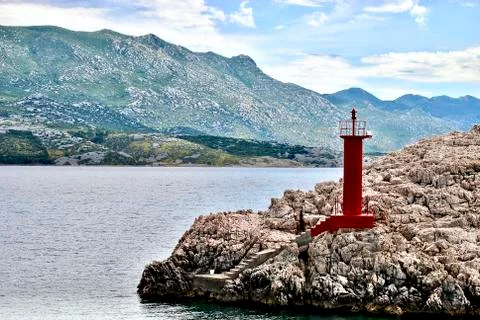 Lighthouse in the middle of the rocks Stock Photos