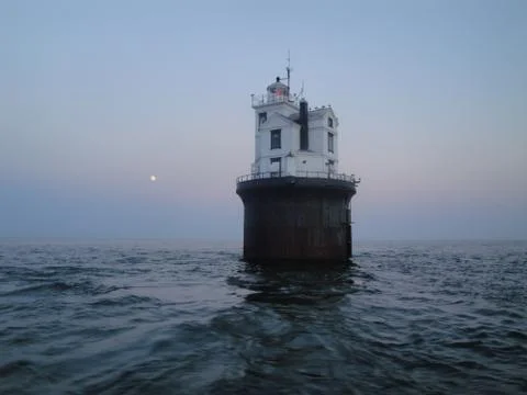 Lighthouse in the middle of the sea Stock Photos