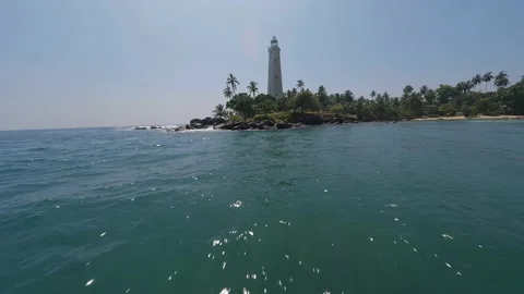 A lighthouse in the middle of a tropical jungle FPV drone view Stock Footage 225865158