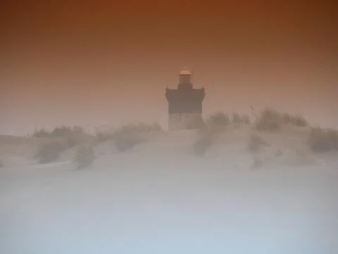 Lighthouse in the mist Stock Photos