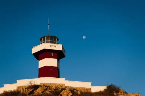 Lighthouse on a mountain with the moon on the sky Stock Photos