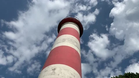 Lighthouse on a moving cloud background. Low angle view. Stock Footage 163063893