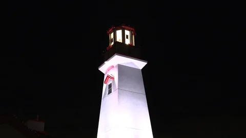 Lighthouse at night with flashing light beacon Stock Footage 99019819
