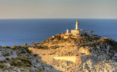 A lighthouse in north majorca at sunset Stock Photos