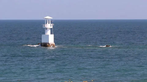 Lighthouse in the ocean with blue sky 库存影片 32785877