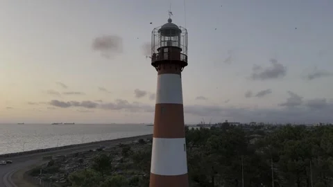 Lighthouse orbit view, showing the sea and sunset at the background while hov Stock Footage 330588348