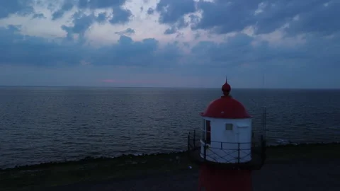 Lighthouse Overlooking Serene Ocean at Dusk, Iconic Landmark Stock Footage 295947141