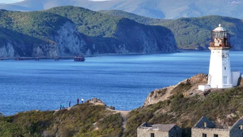 Lighthouse Overlooking Water on Hill Stock Footage 265811820