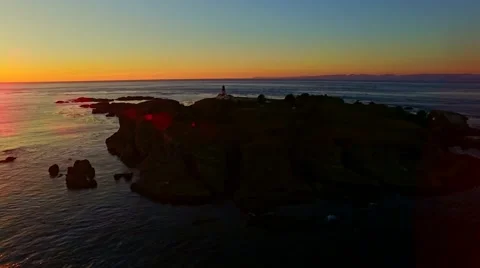 A lighthouse on Pacific ocean at sunset Stock Footage 55661507