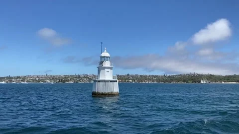 A lighthouse passing in blue water in Sydney Harbour, Australia Stock Footage 231037756