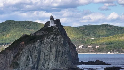 Lighthouse Perched on Rock by Ocean Stock Footage 265809276