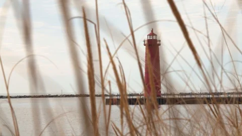 Lighthouse at Pere Marquette through the grass in early spring, 4k60p Stock Footage 128854020