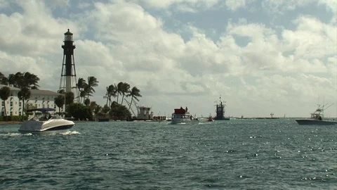 Lighthouse Point-Florida-seascape wide shot-lighthouse-fishing boats pass by Stock Footage 115091553