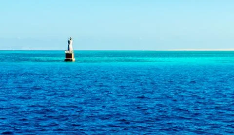 Lighthouse in the red sea. Stock Photos