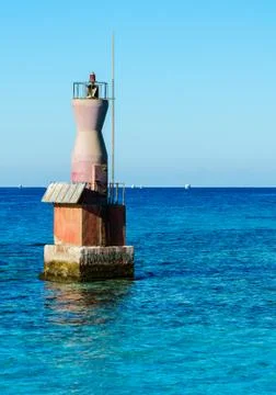 Lighthouse in the red sea. Stock Photos