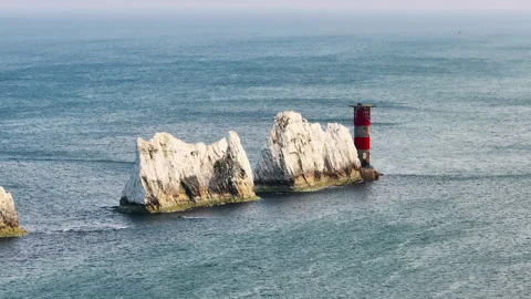 A lighthouse is on a rock in the ocean Stock Footage 298275228