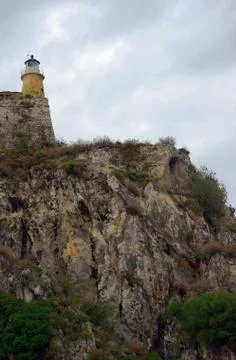 Lighthouse on a rock Stock Photos