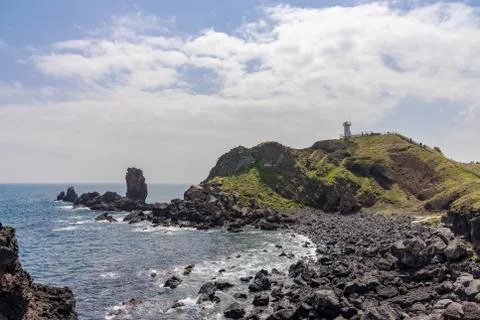Lighthouse on a rock Stock Photos