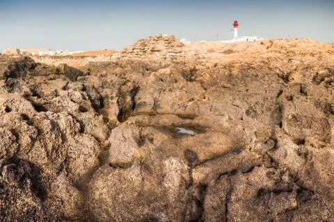 Lighthouse on the rocks Stock Photos