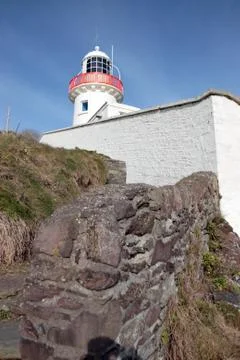 Lighthouse on rocks Stock Photos