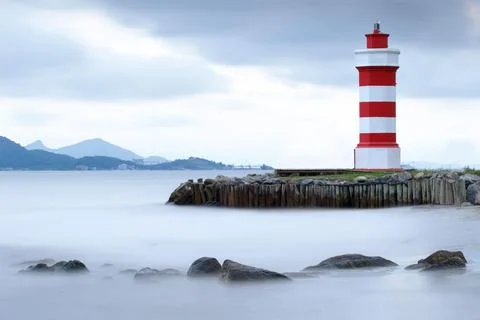 Lighthouse on rocks in the sea 스톡 사진