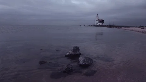 Lighthouse with rocks in the water on the foreground Stock Footage 91182094