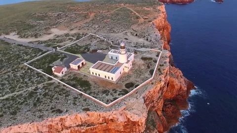 Lighthouse on the rocky cliff during sunrise. Stock Footage 71355640