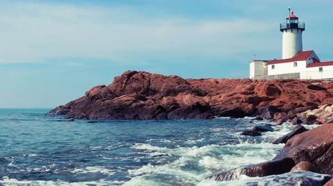 Lighthouse on rocky New England coast Stock Footage