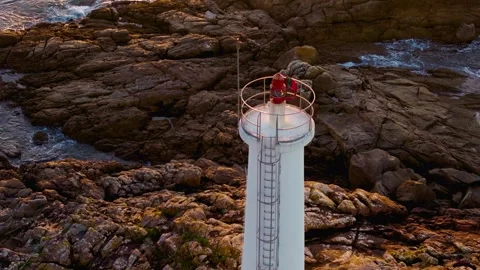 Lighthouse On The Rocky Shores Of Playa do Lago. Aerial Drone Shot Stock Footage 296972163