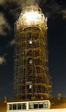 Lighthouse in scaffolding for construction with the light shining at night Stock Photos