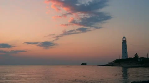 Lighthouse on the sea coast at sunset. Video stock 180544054