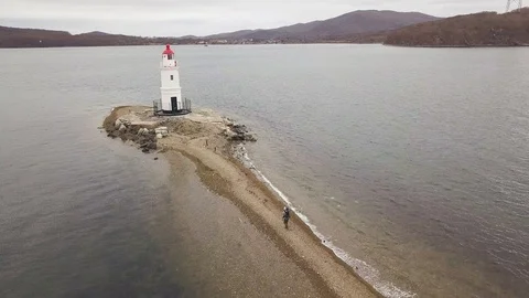 Lighthouse on sea coast view from flying drone. Aerial landscape sea beacon Stock Footage 93392152