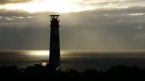 Lighthouse on the sea under stormy clouds and with the ship in the background Video stock 69196315