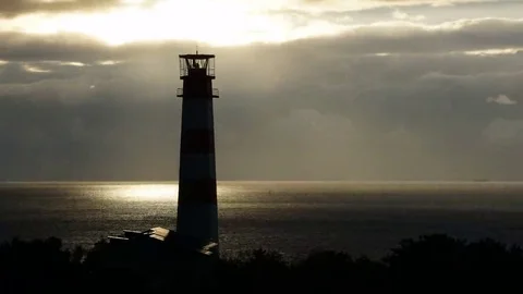 Lighthouse on the sea under stormy clouds and with the ship in the background Stock-Footage 69199102